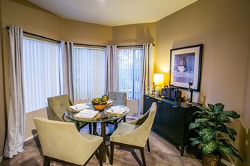 a dining room with a table and chairs